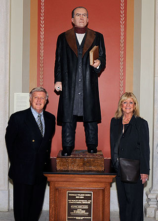 Pat and Gail Conley stand in front of a statue of Thomas Wilson Dorr that they donated to the state of Rhode Island